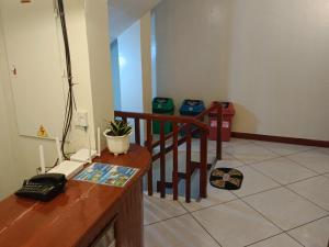 a room with a desk with a phone and a staircase at #1 Green Room Inn Siargao in General Luna