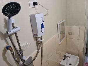 a bathroom with a shower and a sink at #1 Green Room Inn Siargao in General Luna