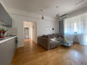 a living room with a couch and a table at 2 bedroom apartment with terrace in City Center in Bucharest
