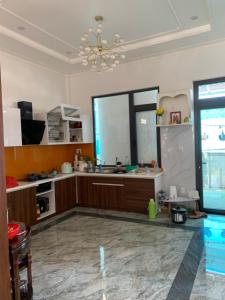 a large kitchen with a chandelier in a room at HUNA House in Da Lat