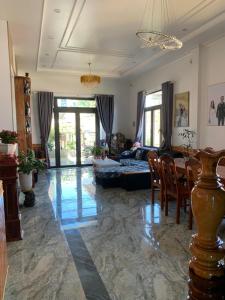 a living room with a table and a couch at HUNA House in Da Lat