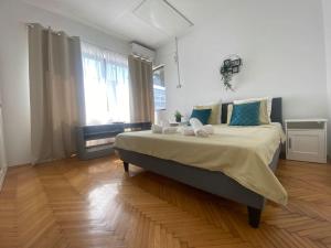 a bedroom with a large bed with blue pillows at 2 bedroom apartment with terrace in City Center in Bucharest