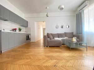 a living room with a couch and a table at 2 bedroom apartment with terrace in City Center in Bucharest