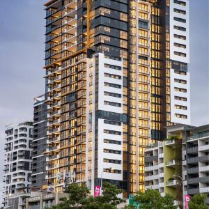 a tall building with many windows in a city at Urban Riverside Escape at Cultural Centre Precinct in Brisbane
