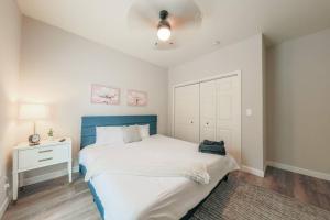 a bedroom with a large bed with a blue headboard at Minutes to Broadway/ 2 KING beds and with FREE garage parking in Nashville