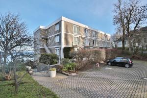 a car parked in a parking lot in front of a building at Haus Miramar Treffert Appartement 21 in Niendorf