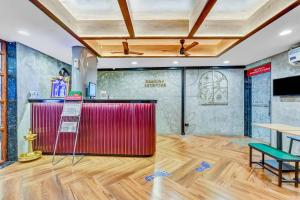 a room with a red counter and a wooden floor at Season 4 Residences - Teynampet Near Apollo Hospital ,Balaji Dental, US Consulate in Chennai