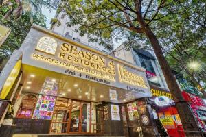 a store with a sign on the side of a street at Season 4 Residences - Teynampet Near Apollo Hospital ,Balaji Dental, US Consulate in Chennai