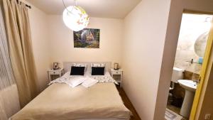 a small bedroom with a bed and a sink at Casa De Gallois in Sinaia