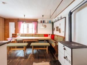 a kitchen and dining room with a table and chairs at Quaint farmhouse in Bramberg am Wildkogel in Neukirchen am Großvenediger