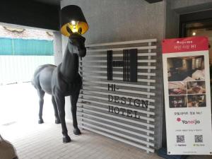 a statue of a horse standing next to a sign at Hi Design Hotel in Busan