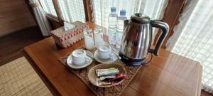 a table with a coffee maker on top of it at Sari Papandayan Resort Syariah in Garut