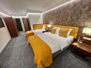 a hotel room with two beds with yellow blankets at Hotel Ines in Sędziszów Małopolski
