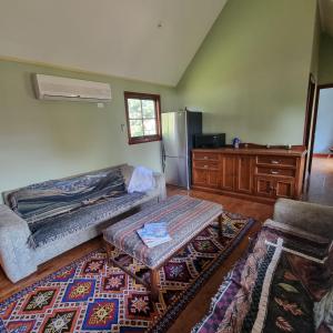 a living room with a couch and a table at Giyabwe Cottage in Macclesfield