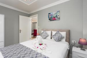 a bedroom with a white bed with a towel on it at Villa Delfin in Ortaca +40 photos