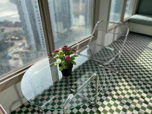 a chair and a plant on a window sill at Landmark Songdo Stay in Incheon