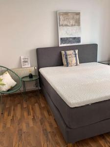 a bed sitting in a room with a table at Cosy Apartment nearly City Hall Vienna and Subway in Vienna
