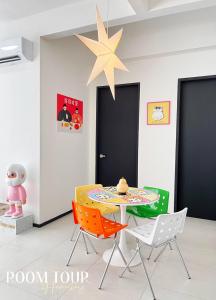 a table and chairs in a room with a star on the ceiling at Urban Suites @Jelutong Georgetown in Jelutong