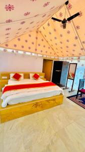 a bedroom with a bed in a tent at Desert Malra Camp in Jaisalmer