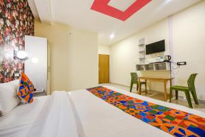 a hotel room with a bed and a desk at FabHotel Sizzling Resort & Adventure in Dhanaulti