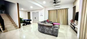 a living room with a couch and a television at 19pax Ipoh Semi-D W Shared Pool Table & Karaoke ISD03 R in Ipoh