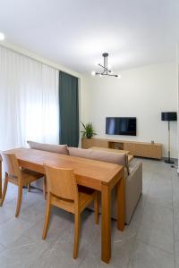 a living room with a wooden table and a couch at ZT Luxury Apartment in Xanthi