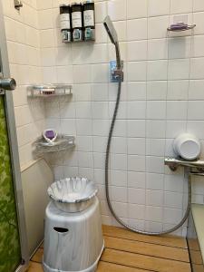 a bathroom with a shower with a toilet in it at Jonni`s Place in Sakamoto