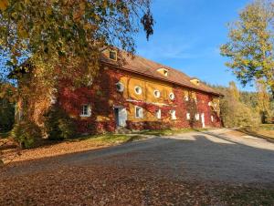 an old brick building with a driveway in front of it at Ferienwohnung Ottmanach Josefhof in Pischeldorf