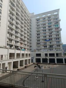 two tall apartment buildings in a city with a courtyard at The Awadh Retreat in Lucknow