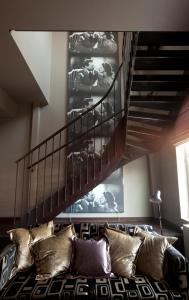 a living room with a couch and a staircase at Clarion Collection Hotel Folketeateret in Oslo