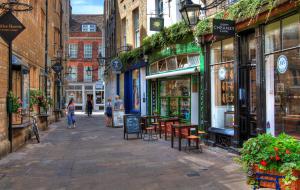 a street in a city with people walking down it at Luxury Apartment with King-size Bed in Central Cambridge - Walk to Station and City Centre in Cambridge