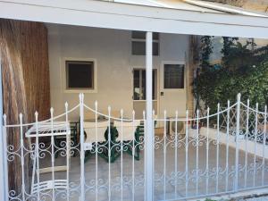 a white fence in front of a house at center apartments in Lefkada