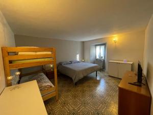 a bedroom with a bunk bed and a desk at Cà di Lucca in Lizzano in Belvedere