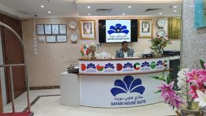 a man sitting at a reception desk in a salon at Safari House Suite in Kuwait