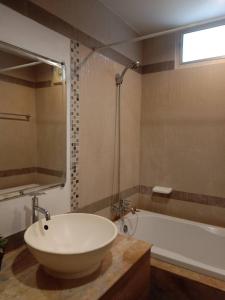 a bathroom with a large white tub and a sink at NOP PLACE BANGNA in Ban Bang Phrao +10 photos
