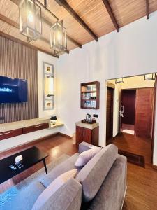 a living room with a couch and a tv at Kubura Resort in Anuradhapura
