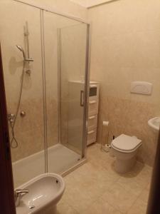 a bathroom with a shower and a toilet and a sink at Brunelleschi House with garden in Fiumicino