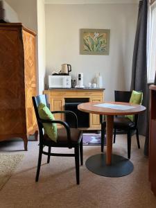 a living room with a table and chairs at moon river chambre d'hote in Saint-Junien