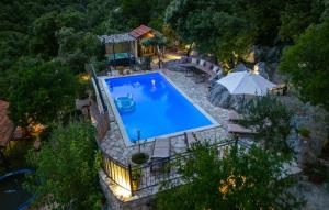 an overhead view of a swimming pool with an umbrella at Rural house Janjić in Ploče