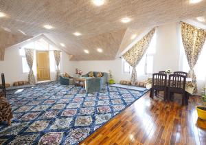 ein großes Wohnzimmer mit einem blauen Teppich auf dem Boden in der Unterkunft Moustache Srinagar in Srinagar