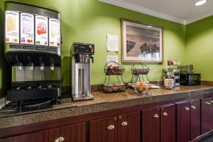 a kitchen with green walls and a counter with a coffee maker at Heritage Inn Express Chico in Chico
