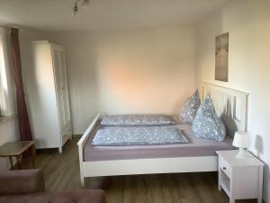 a bedroom with a bed with blue pillows at Ferienwohnung 3 in Dahme