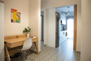 a kitchen with a wooden table and a refrigerator at Panagiotidis lake house in Kastoria