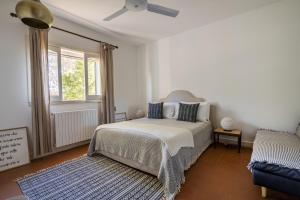a bedroom with a bed and a ceiling fan at House in Villa Torto in Monopoli +32 photos