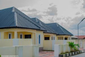 a row of houses with black roof at Tegsview Apartments, Ughelli in Ughelli