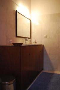 a bathroom with a sink and a mirror at Stone Mansion House in Skopelos Town