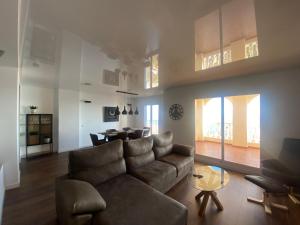 a living room with a couch and a table at Luxury Penthouse Playas de torrevieja 6pax in Torrevieja
