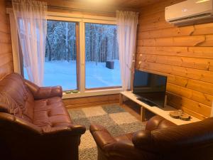 a living room with a couch and a large window at Levi Piippo 2 in Kittilä