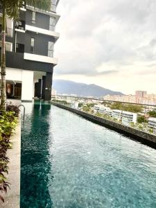 a pool of water in front of a building at Urban Suites @Jelutong Georgetown in Jelutong