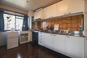 a large kitchen with white cabinets and a large window at 天满橋 Home - elevator, suite room washmachine, kitchen 2 toilet 2 bathroom or 2 toilet 1 bathroom in Osaka